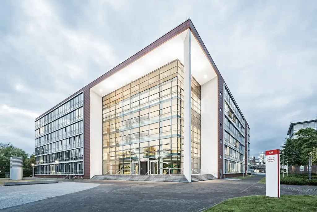 The Henkel headquarters building in Düsseldorf at dusk.